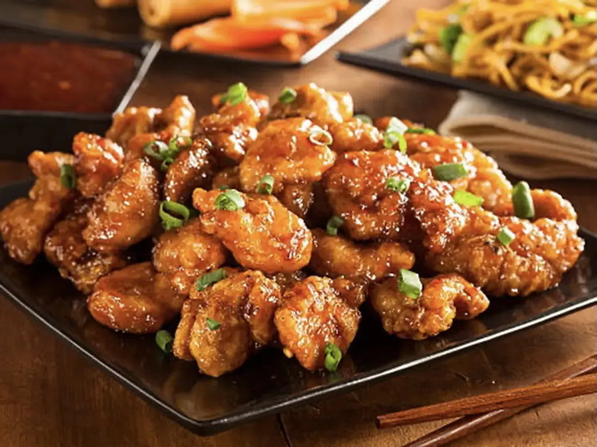 Crispy orange chicken garnished with green onions at Pokéloha, a Asian Fusion Restaurant in Woonsocket