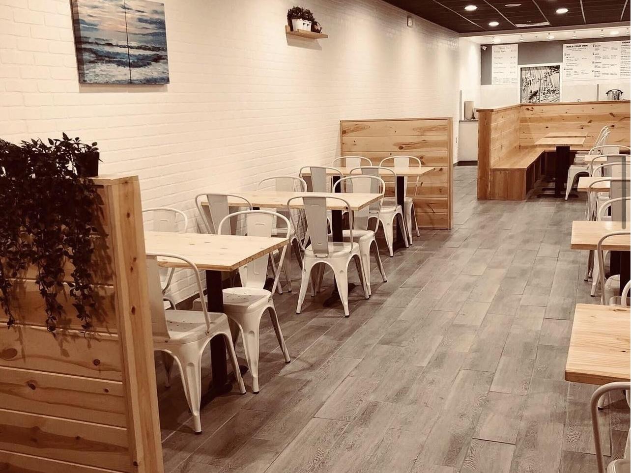 Minimalist dining area with wooden partitions at Pokéloha, a Asian Fusion Restaurant in Woonsocket